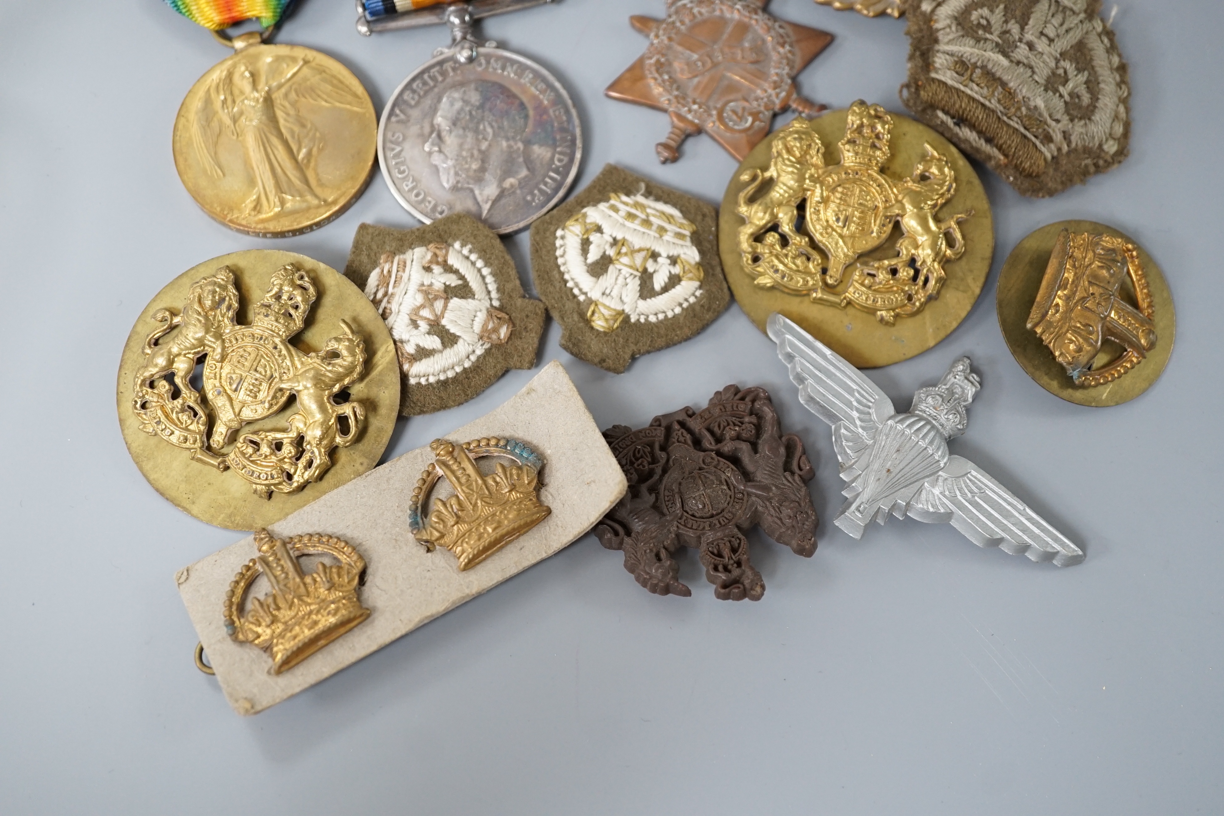 Two WWI medals, collection of cap badges and buttons, Queen Mary tobacco tin and a 66th Infantry Brigade concert party clickety clack cigarette case etc